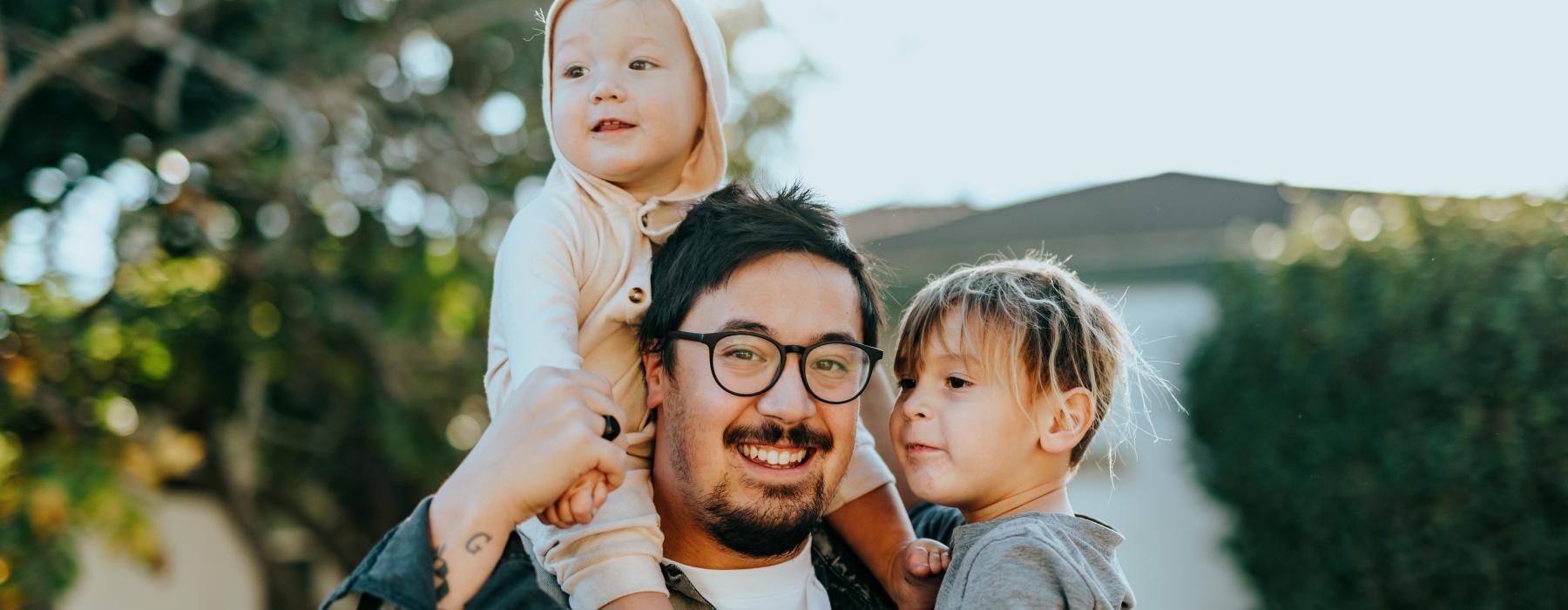 a person holding a couple of children