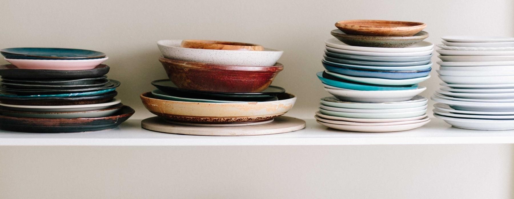 a shelf with bowls and plates on it